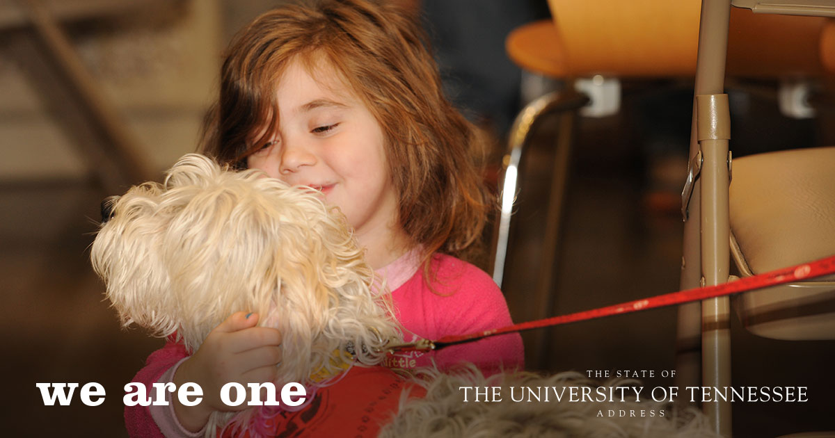 5 year old Zoey Lively plays with a HABIT dog at the Rocky Mountain Shelter