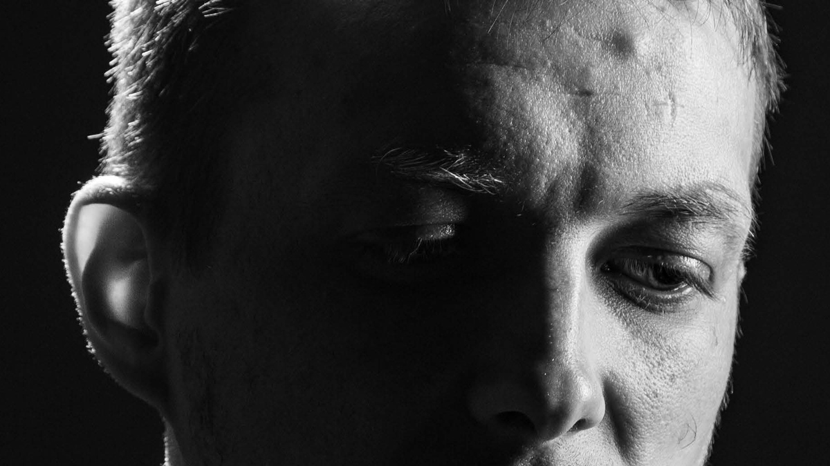 Close-up black and white image of the face of man.