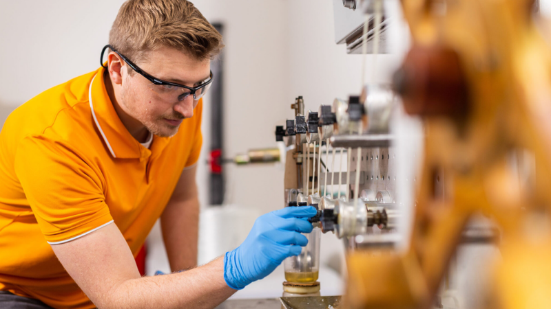 Person in safety goggles working in a lab