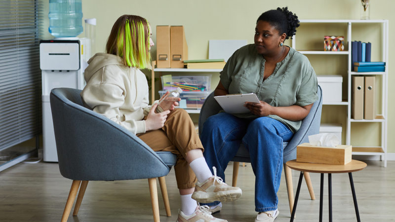 A counselor and client speak with each other in a clinic setting
