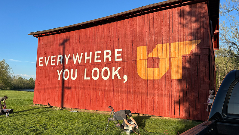 Exterior photo of red barn with Everywhere You Look, UT mural