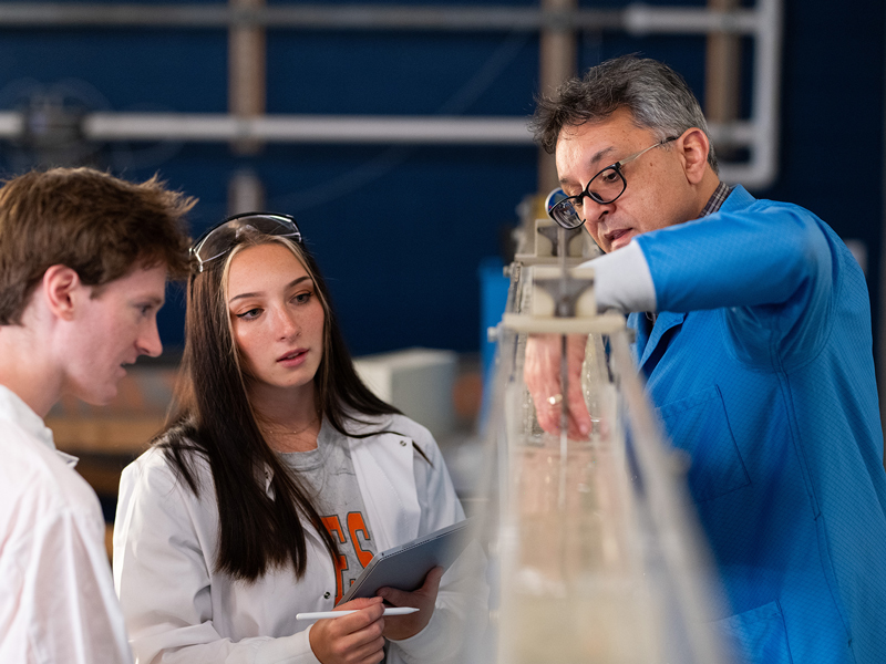 Students and professor at a water hydraulics lab.