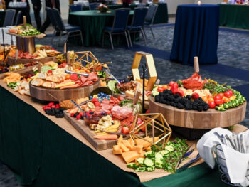 A catered spread with a variety of food displayed on a table during a Holiday Party for Chancellors.