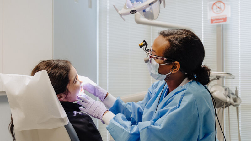 Dental student working on a patient.