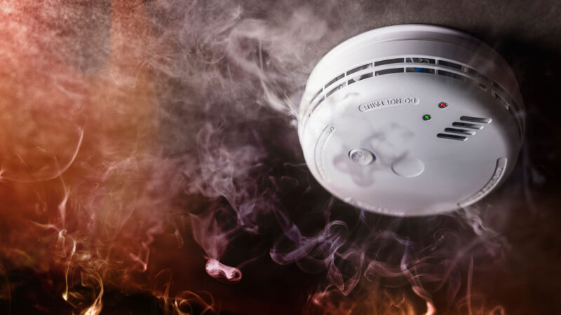 Fire alarm surrounded by smoke, Adobe Stock Photo
