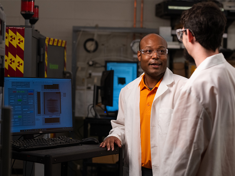 Post-doctoral researcher Stephen Young and Volkswagen Fellow Edward (Joey) Michaud test a 3D-printed sample in a Dayakar Penumadu lab in the John D. Tickle Engineering Building on July 24, 2023. Photo by Jennie Andrews/Freelance Photographer/University of Tennessee. UTK