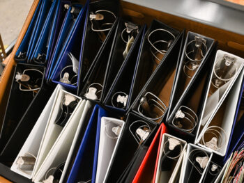 A box of red, black, white, and blue binders.