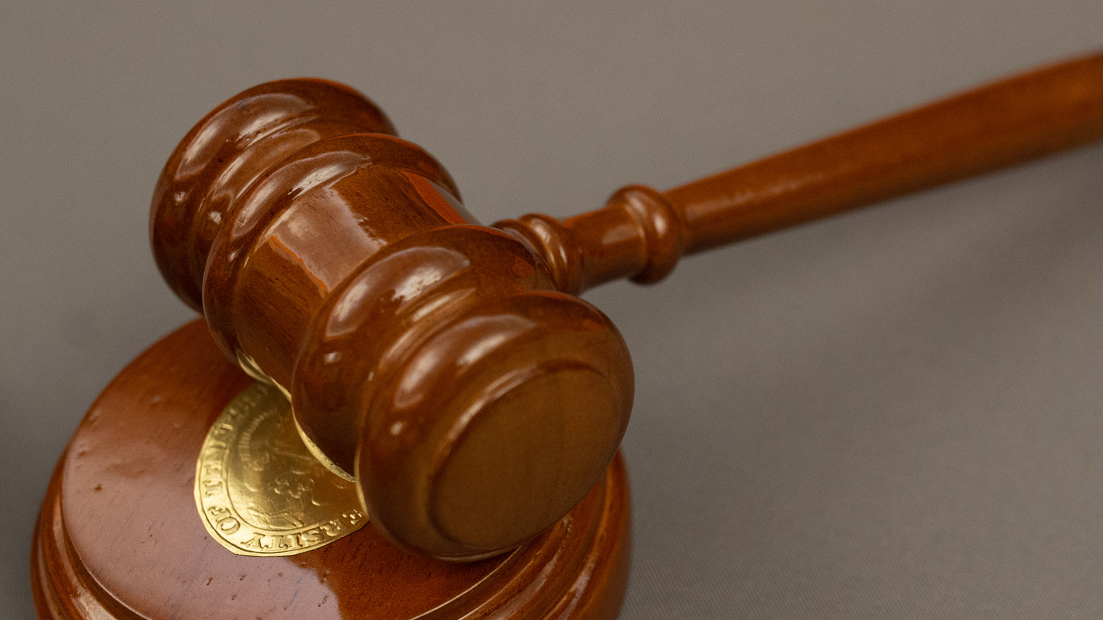 A wooden gavel with the University of Tennessee Seal in brass