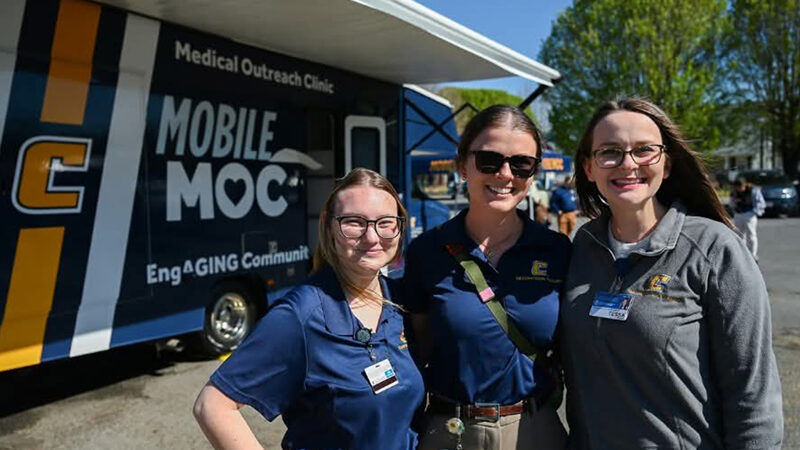 UT Chattanooga nursing students pose with the new Mobile Mocs, a mobile outreach healthcare clinic.