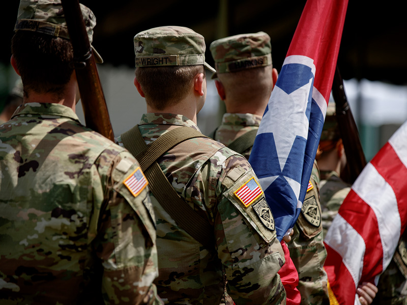 A line of ROTC students taking part in a Color Guard formation.