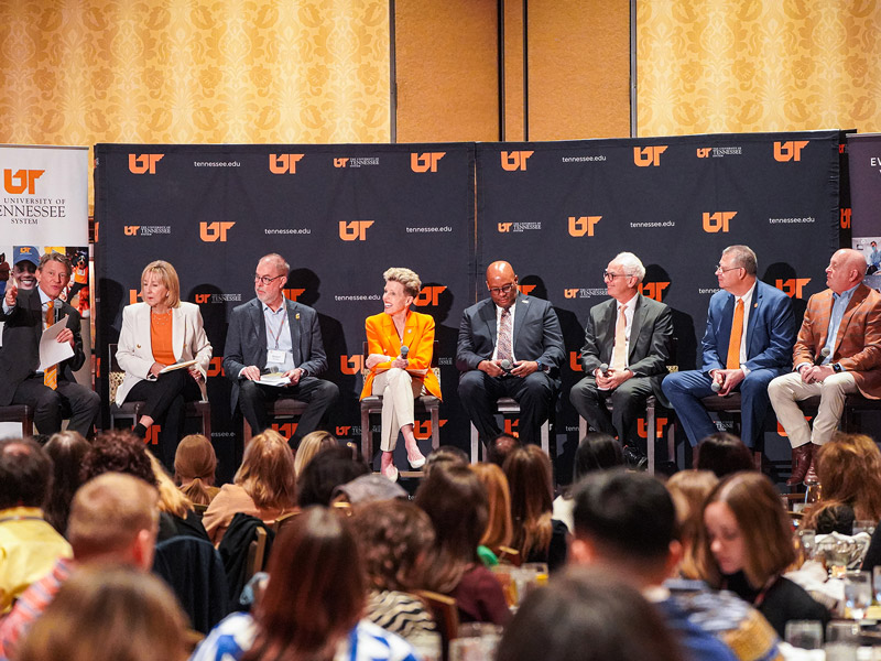 The UT President and campus chancellors sitting on stage during a panel discussion.