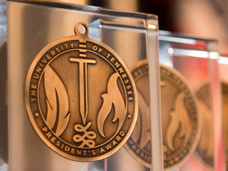 A clear, acrylic awards plaque containing a bronze medallion with the words "The University of Tennessee President's Award."