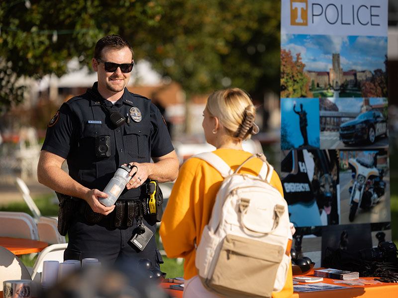 A UTPD officer visits with a student during the first day of Fall classes on August 23, 2023. Photo by Steven Bridges/University of Tennessee.