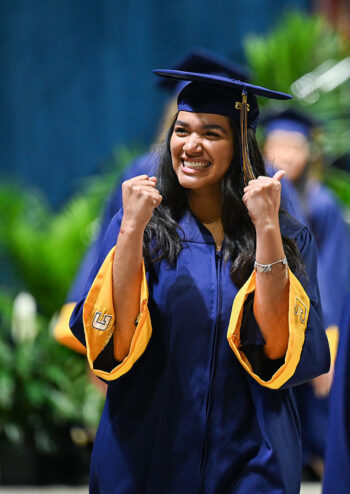 A student celebrates graduation during commencement.