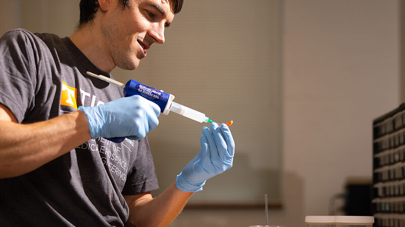 Dustin Crouch, UTK assistant professor, covers a 3D printed part with silicone while making prosthetic feet in the Upper Limb Assist Lab inside the Dougherty Engineering Building. (Photo by Breven Walker)