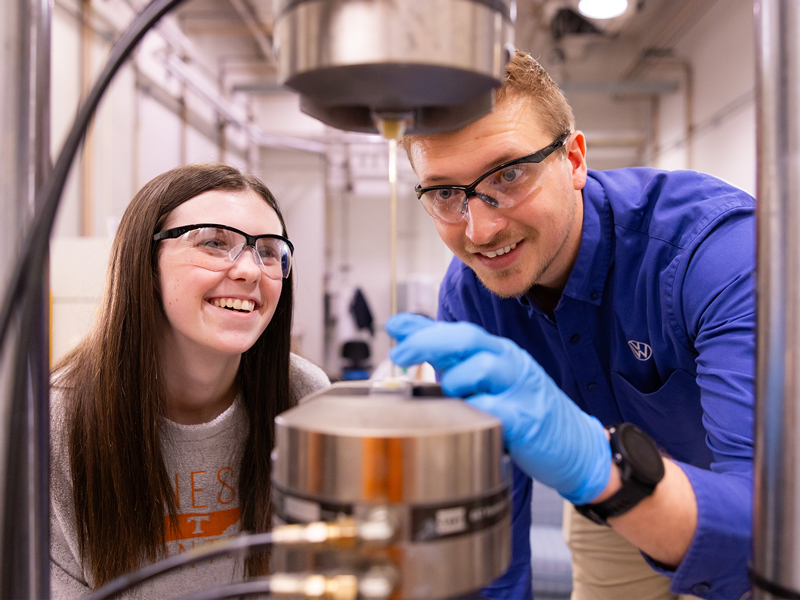 A male and female working on glass fiber tensile.