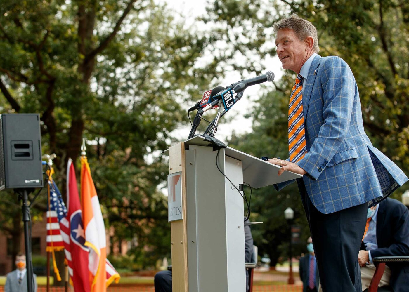 UT System President Randy Boyd speaks from behind a podium while attending an outdoor event at UT Martin.