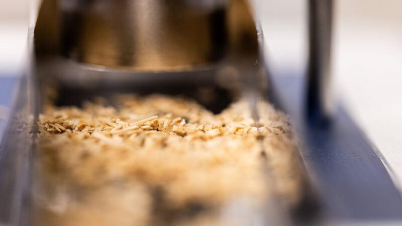 A metal chute filled with cuts of grain.