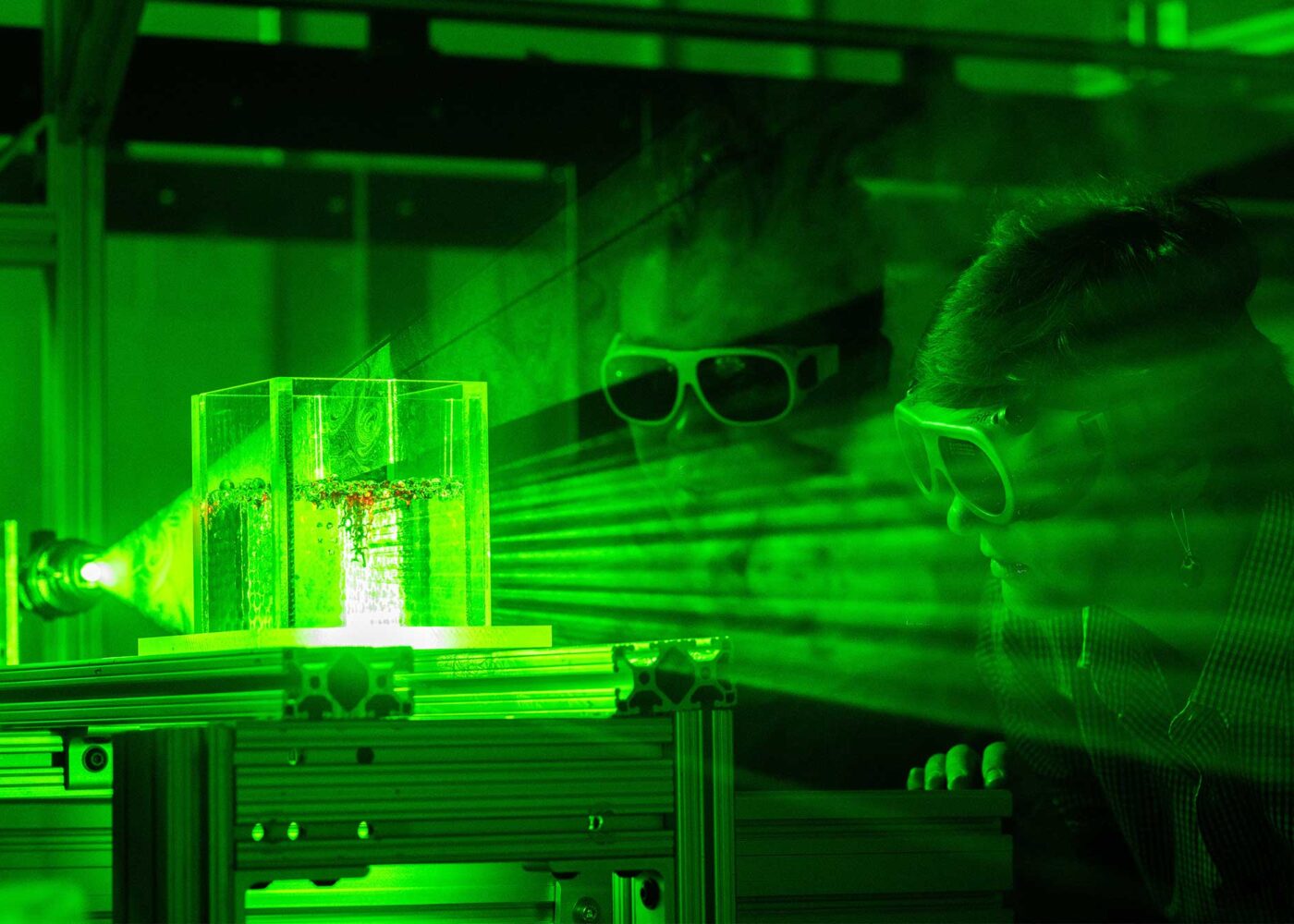 Two people example an experiment using laser beams.