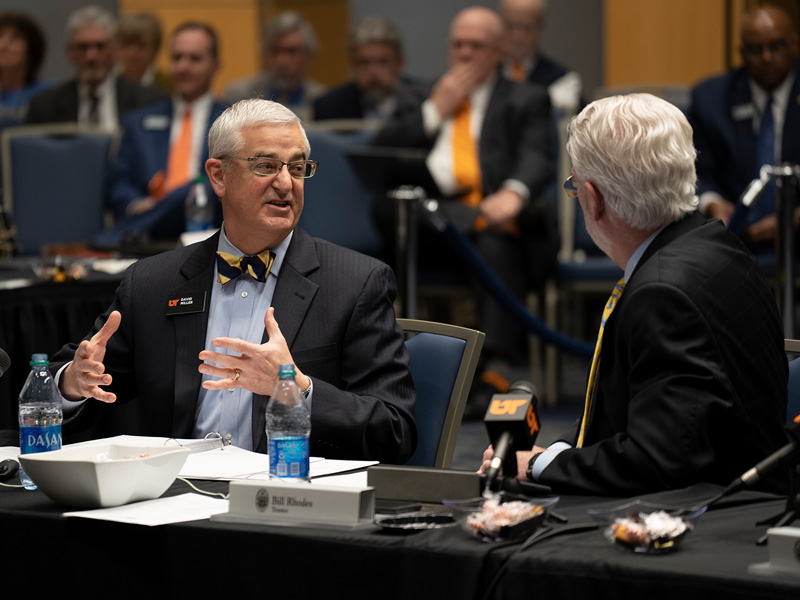 A group of people in business suits having a discussion during a meeting.