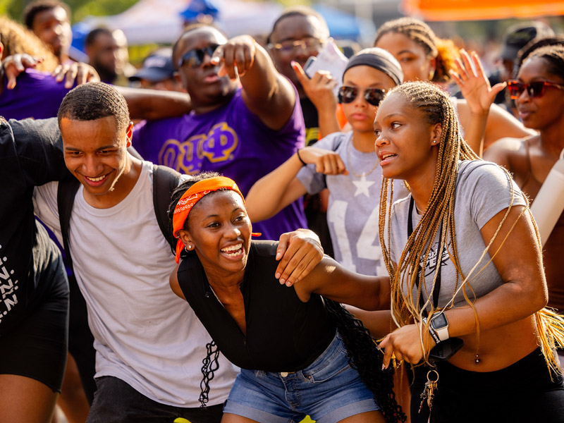 A group of black students dancing together.
