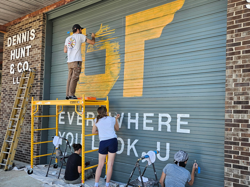Muralists painting the Everywhere You Look, UT Mural in Coffee County.