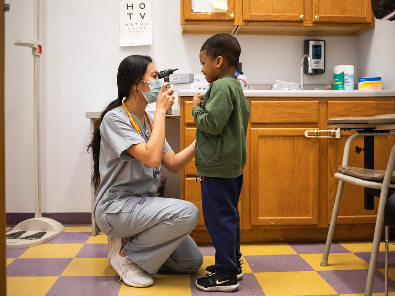 A College of Nursing student performs a child checkup while working at the Vine School Health Center on May 13, 2021. Photo by Steven Bridges/University of Tennessee.