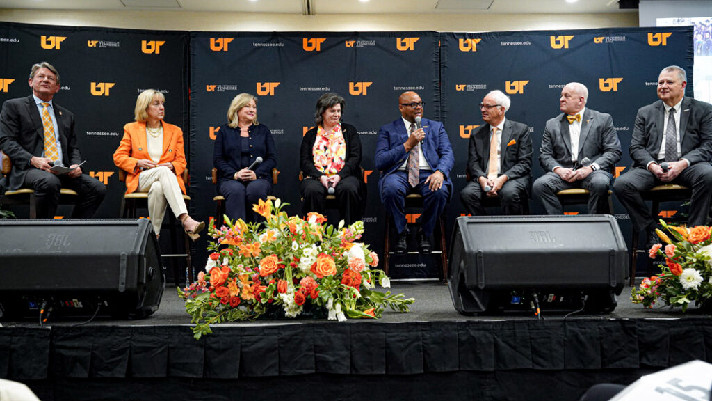 The UT President and campus chancellors sitting on stage during a panel discussion.