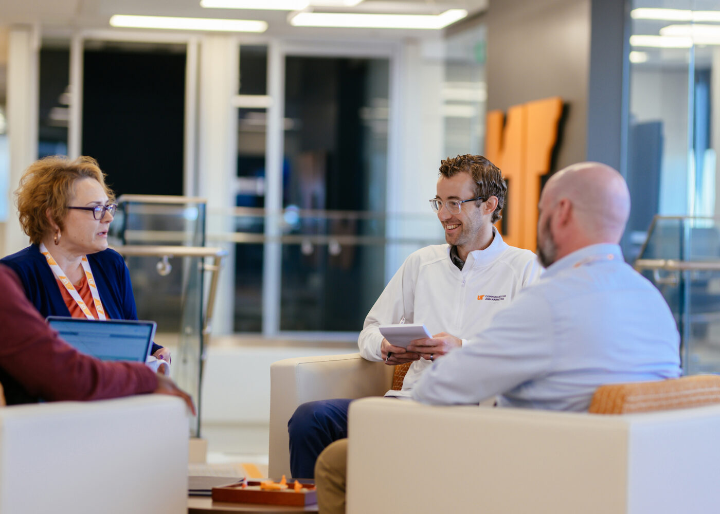 Group of UT System coworkers meeting together in a common area.