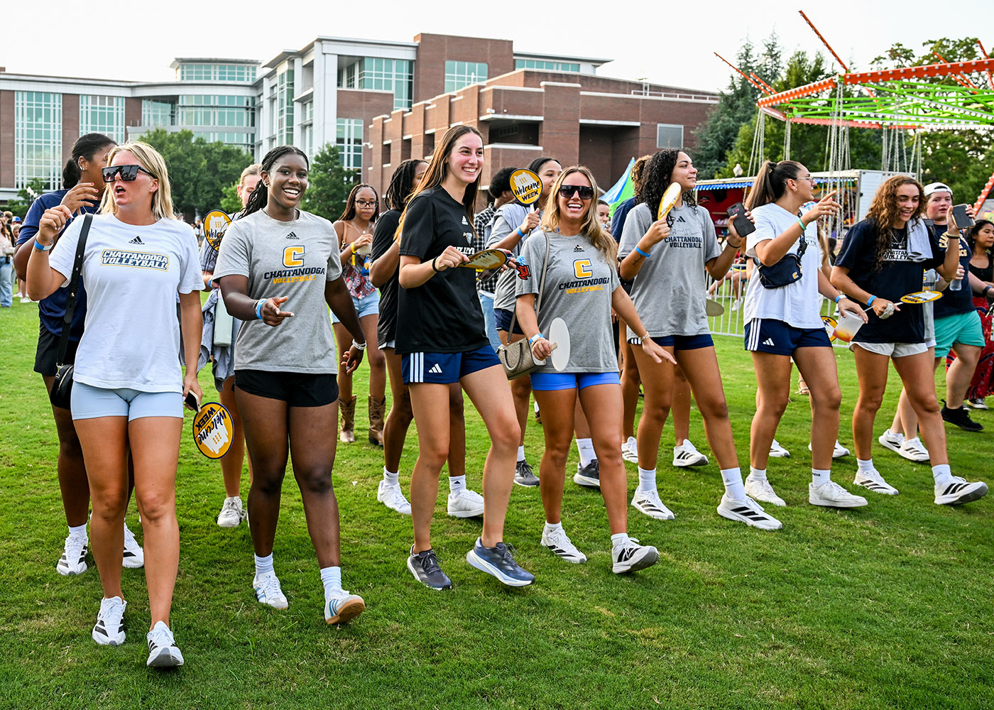 A line of female students performing a line dance at a campus community event.